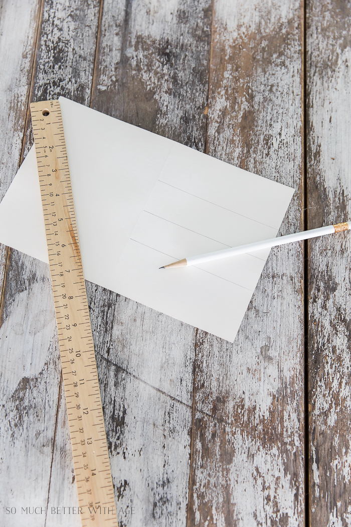 A ruler, paper and a pencil on the table.