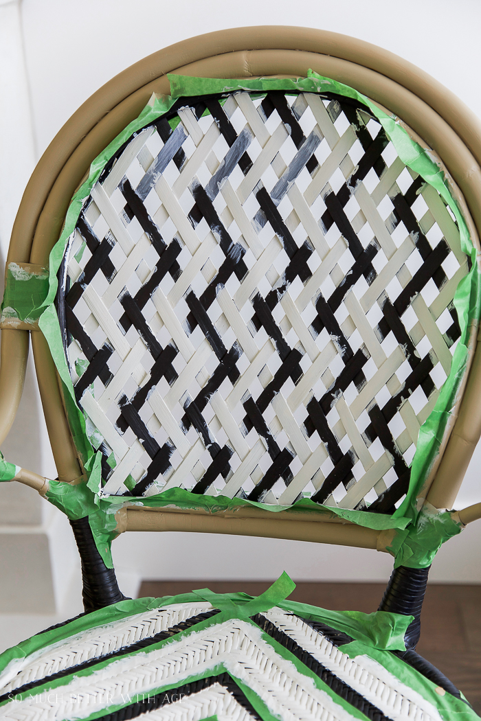 Painting the lattice on the seat of the chair.