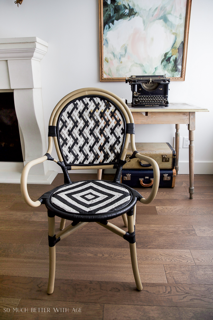 DIY French Bistro Chair/ ikea chair, wicker and rattan, bamboo look, vintage typewriter, vintage suitcases, french artwork on wall.