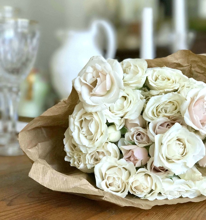 A bouquet of white roses on the counter.