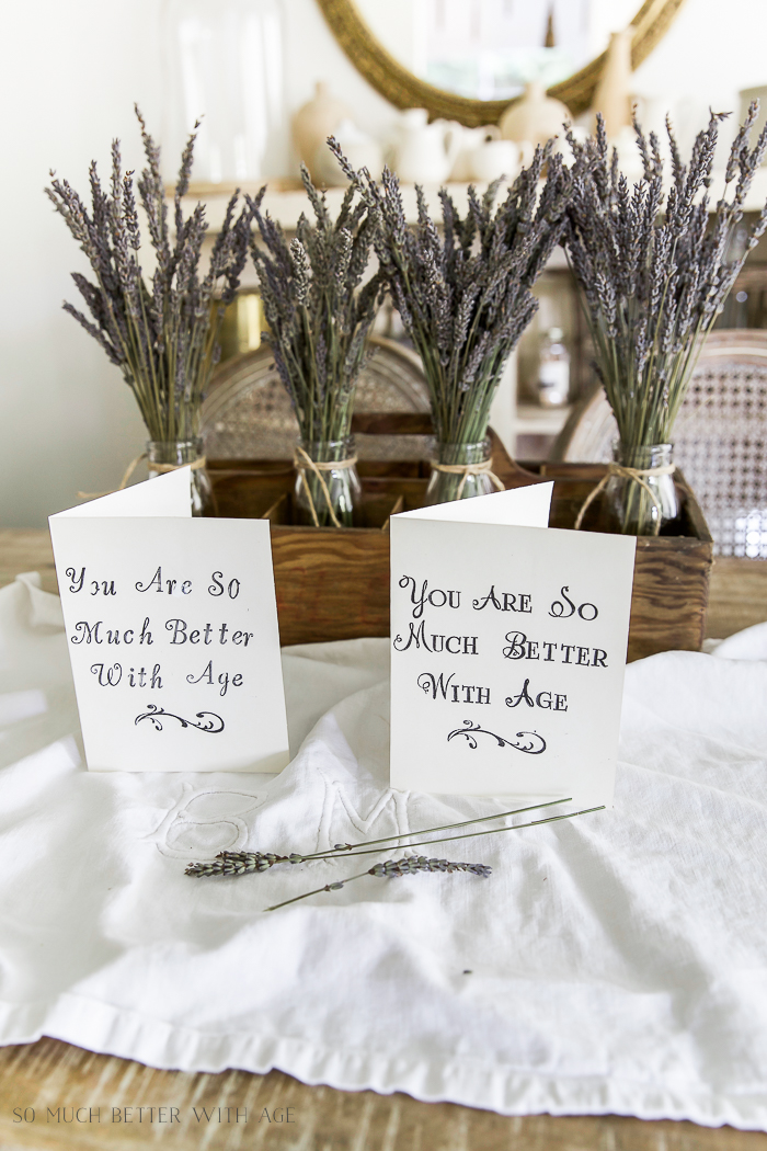 Two stamped cards on linen with lavender in front of the cards.