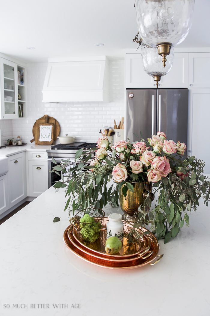 Roses and eucalyptus on the counter in kitchen.