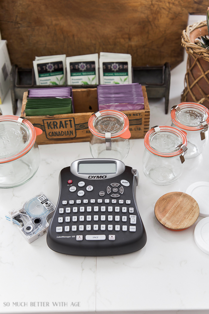 A Dymo label maker on the counter beside the glass jars.