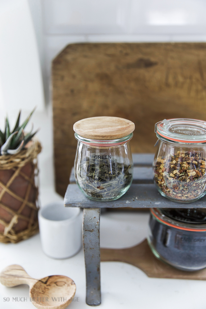 A glass container that says green and another that says peach.