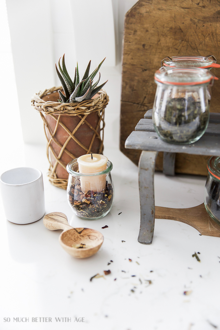 There is a small glass jar with loose tea in it plus a candle.