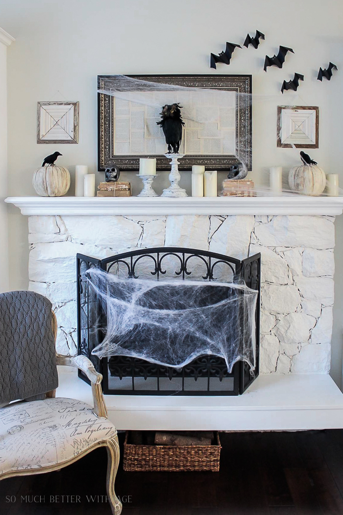 Fireplace with a spider web wrapped around the front of it.