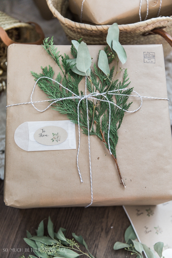 A sprig of evergreen tied onto the present with a gift label.
