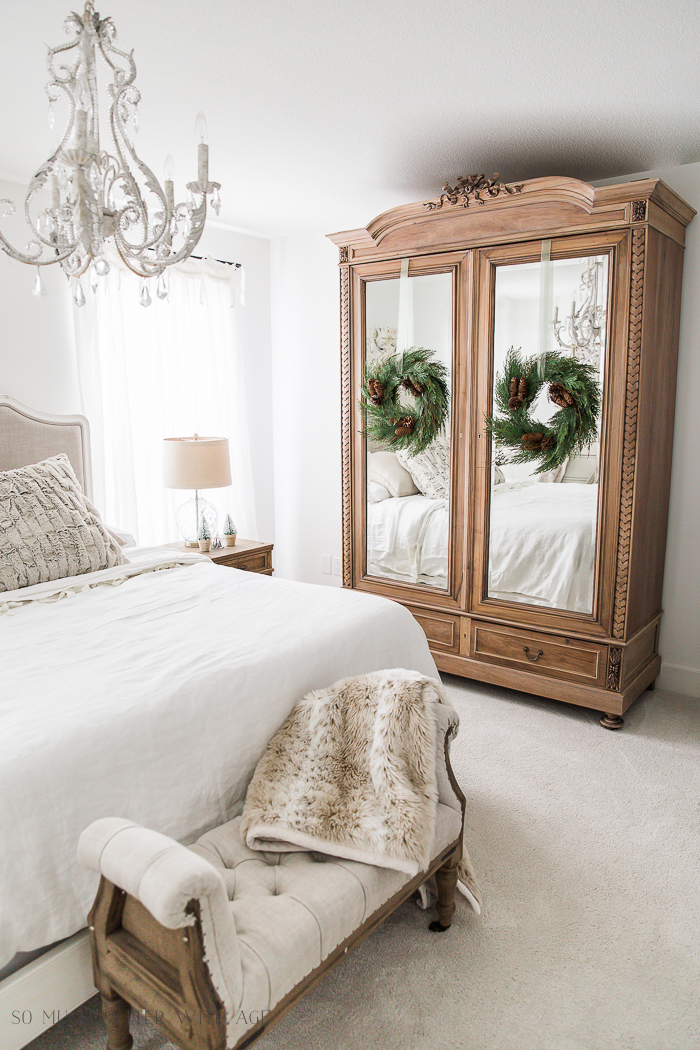 French Master Bedroom Christmas Tour/wooden armoire with Christmas wreaths hanging on it.