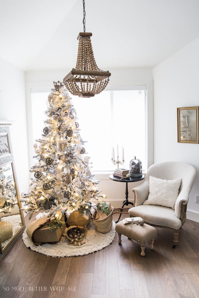 Wooden beaded chandelier in living room above the gold Christmas tree.