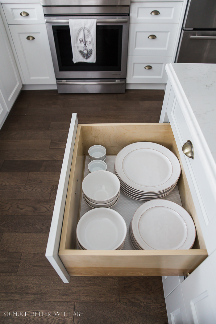 Complete Kitchen Supply List/white plates and bowls in kitchen drawer- So Much Better With Age