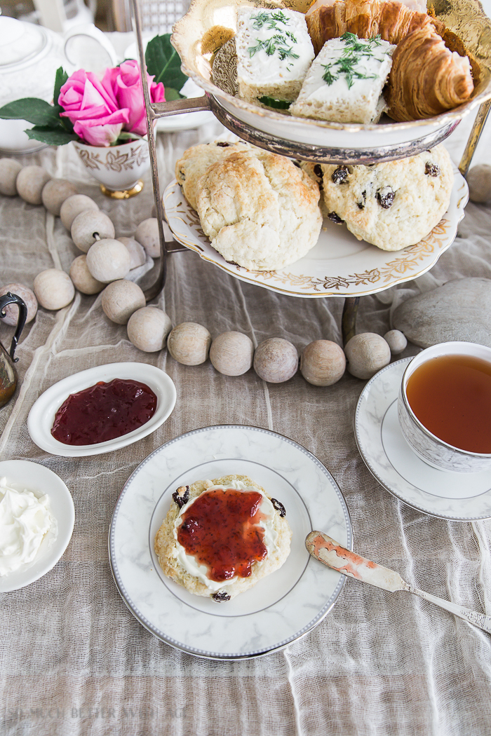 The Best Ever Empress Tea Scones/ scones with clotted cream and jam, tea on the table.