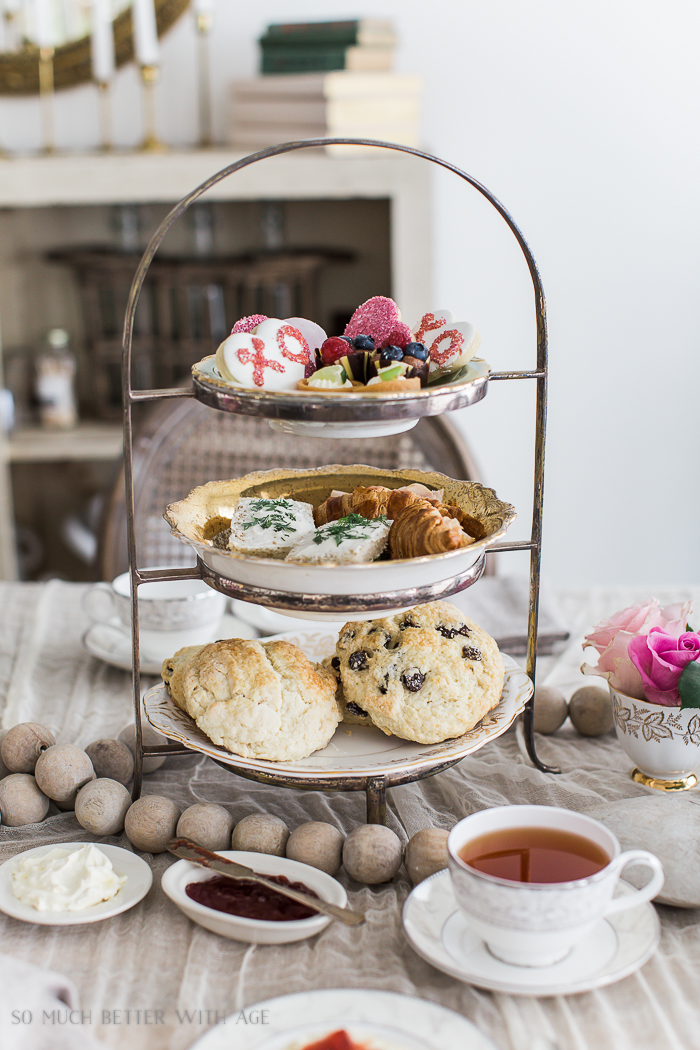 The Best Ever Empress Tea Scones  on a metal rack with other desserts.