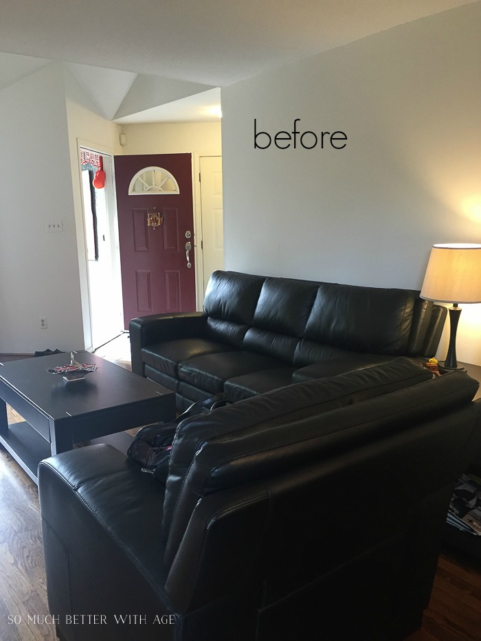 Before picture of leather black couches in the living room.