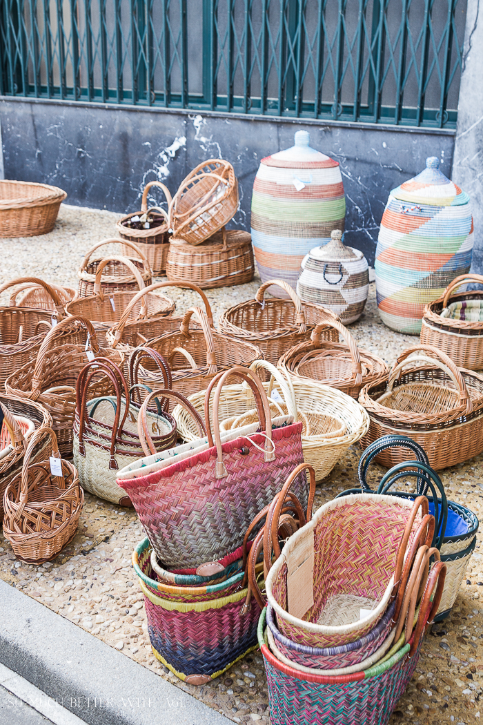 Shopping in Riberac, France with baskets on the ground in a market.
