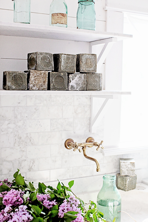 Square green French soaps on white shelf in vintage kitchen by Dreamy Whites.