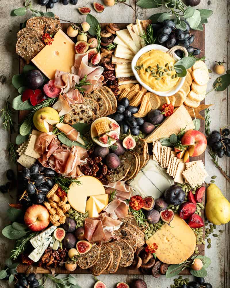 Charcuterie board with crackers, figs, apples, pears, and thyme from Wild Thistle Kitchen. 