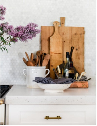 Wooden boards and vintage items on kitchen counter by Boxwood Avenue.
