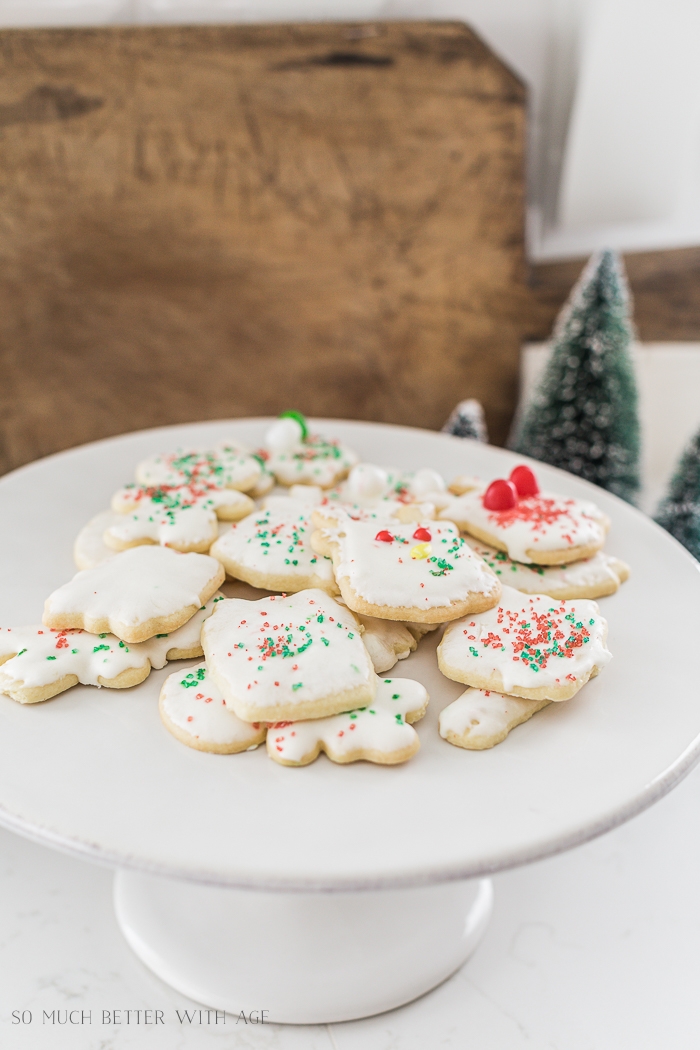 Sugar cookies stacked up on a cake stand.