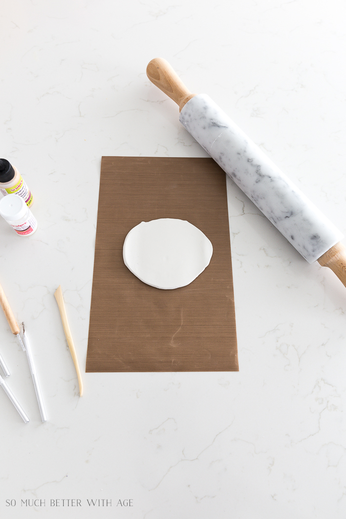 Rolling out the clay on the counter with a marble rolling pin.