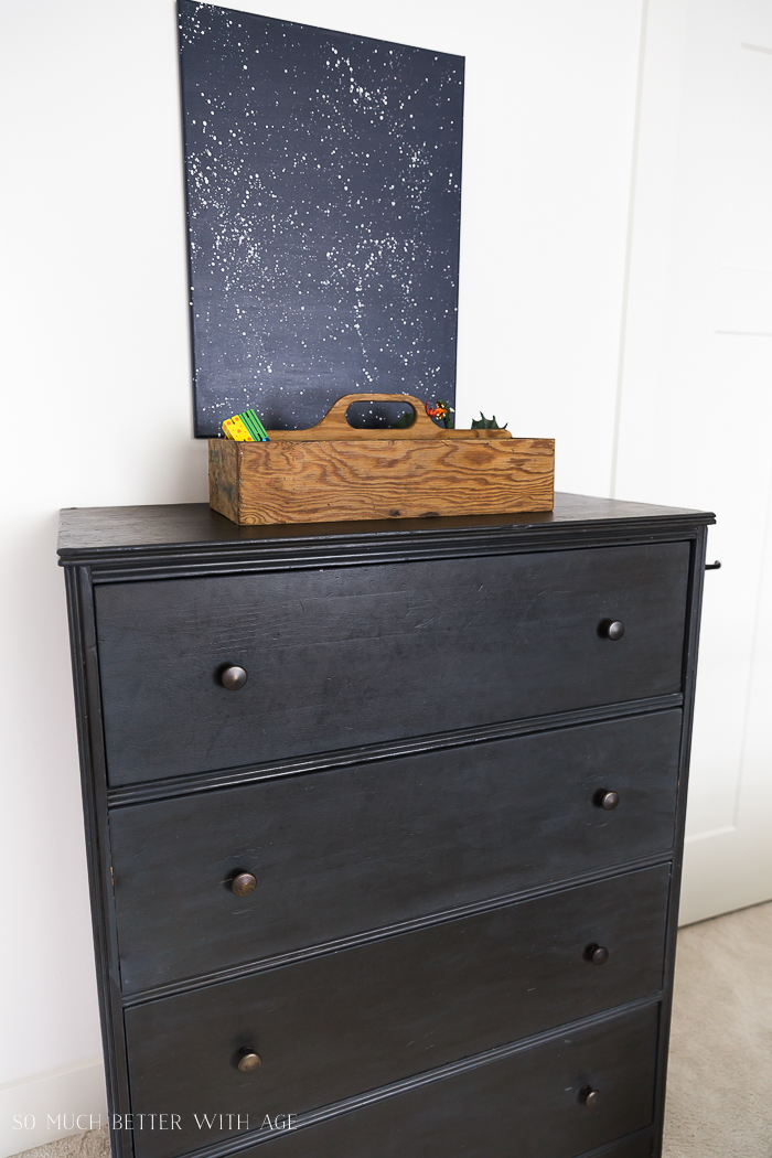 A grey dresser with a wooden box on top.