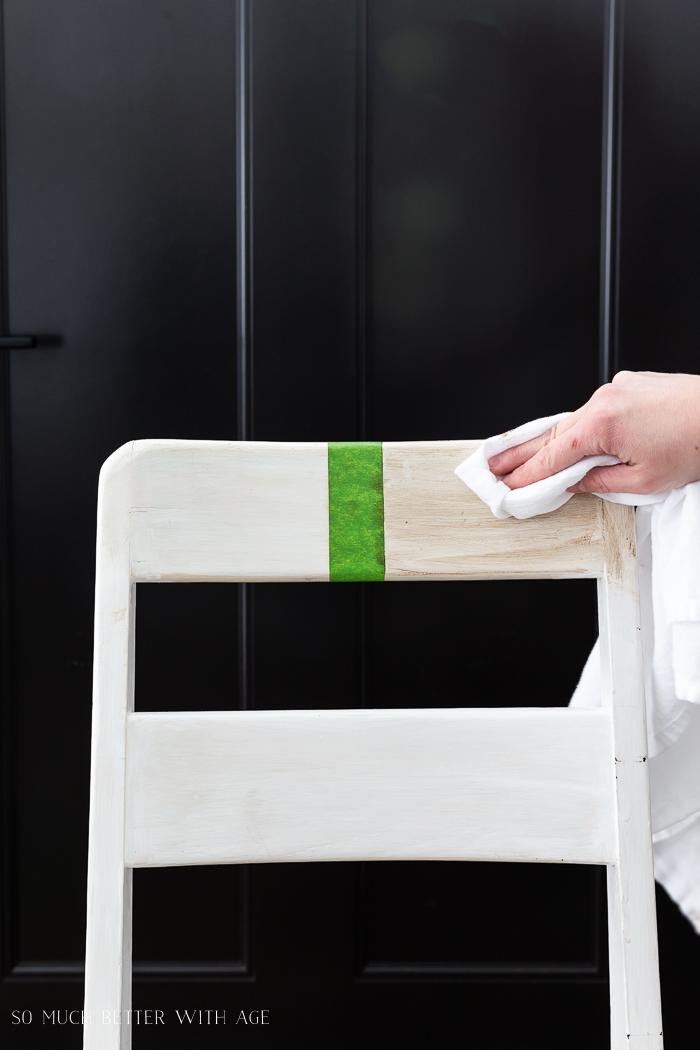 Wiping the wax off the other side of the chair to show the difference.