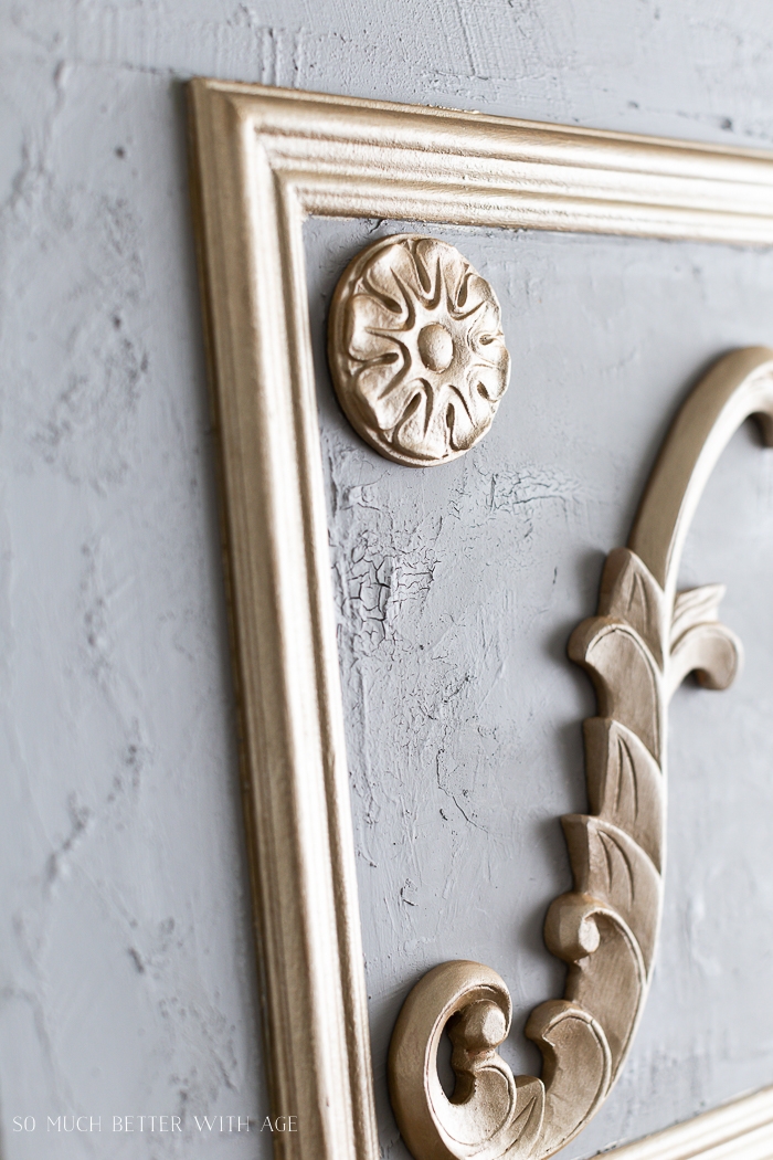 Grey plaster with gold appliques. 