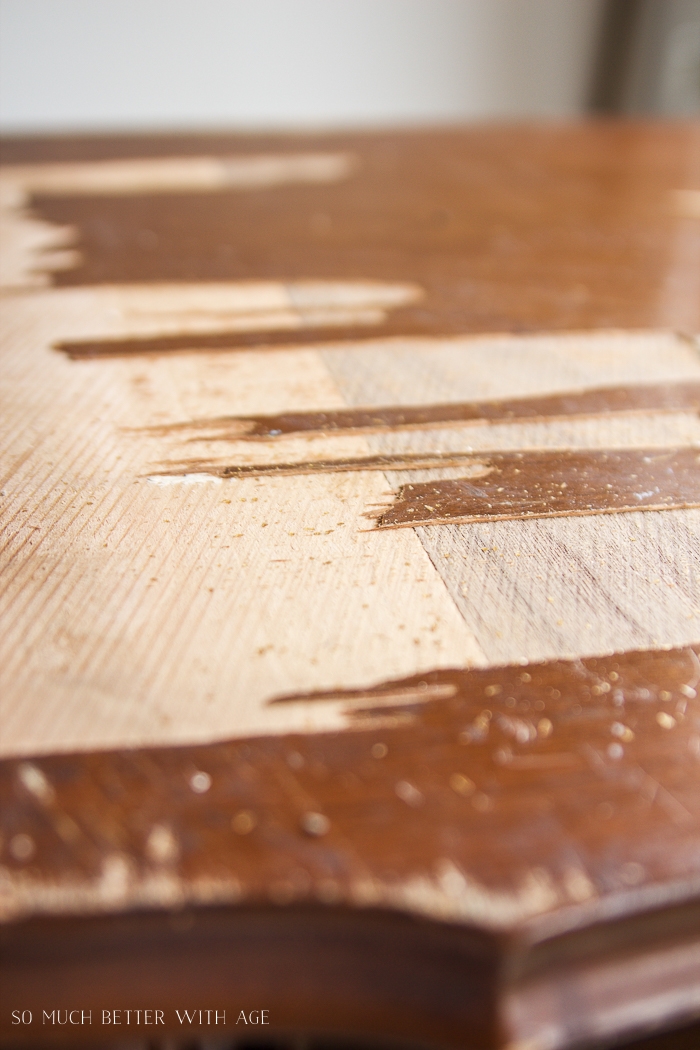 Close-up of wood veneer coming off dresser. 