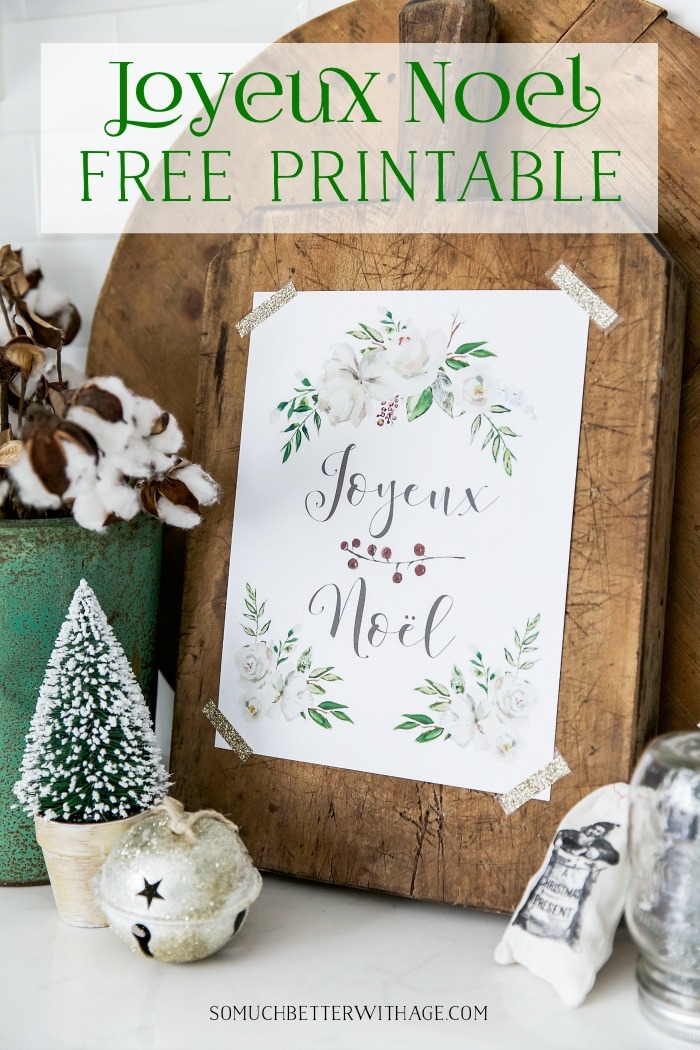 Joyeux Noel Free Printable taped to the wooden cutting board.