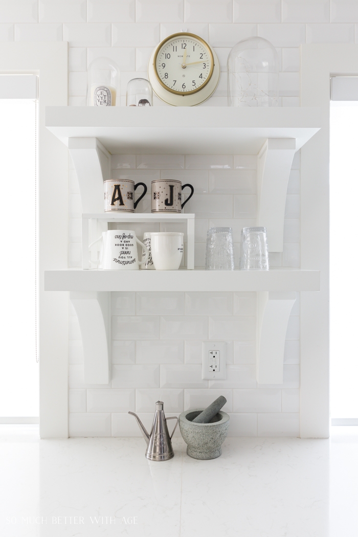 White subway tile, white open shelving in kitchen. 