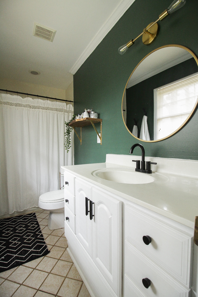 Green painted wall in bathroom by Cassie Bustamante. Rockgarden by Sherwin Williams. 