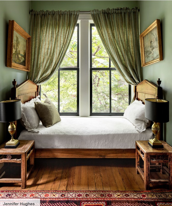 Green walls and curtains with red rug bedroom design by Thomas Woltz.