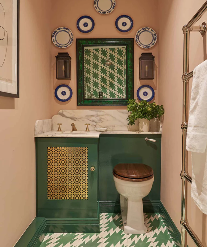Green, blue and peach colored bathroom designed by Vanrenen Hanbury Design. 