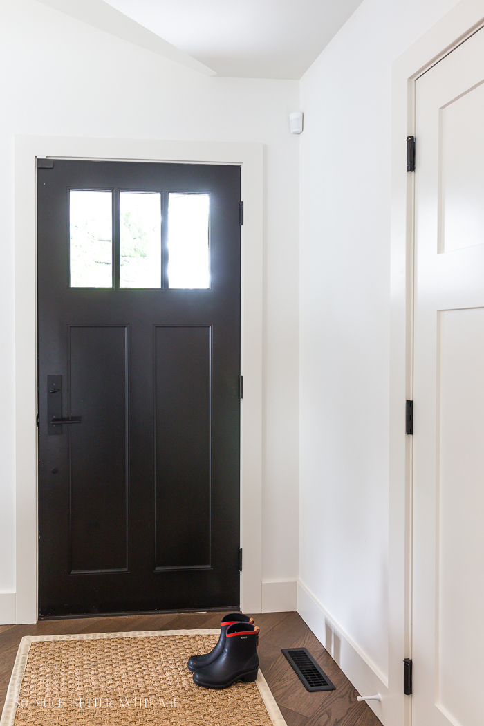 A black front door on the inside of the house.