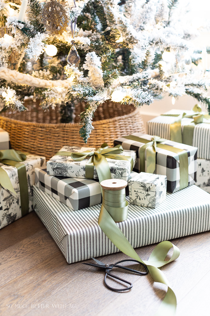 Black and white wrapped Christmas gifts with green satin ribbon. 