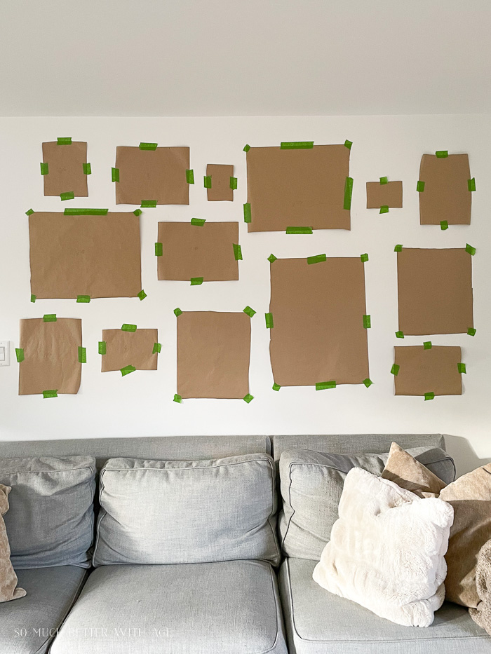 Kraft paper taped on wall above couch with green painter's tape. 