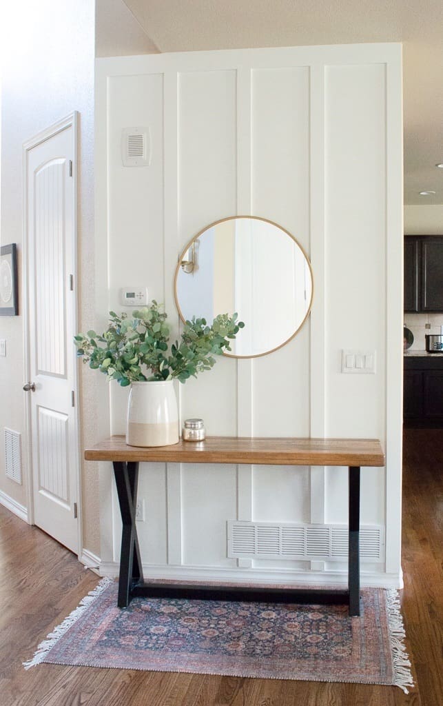 Foyer by Making Home Pretty with board and batten and wooden table and round gold mirror. 