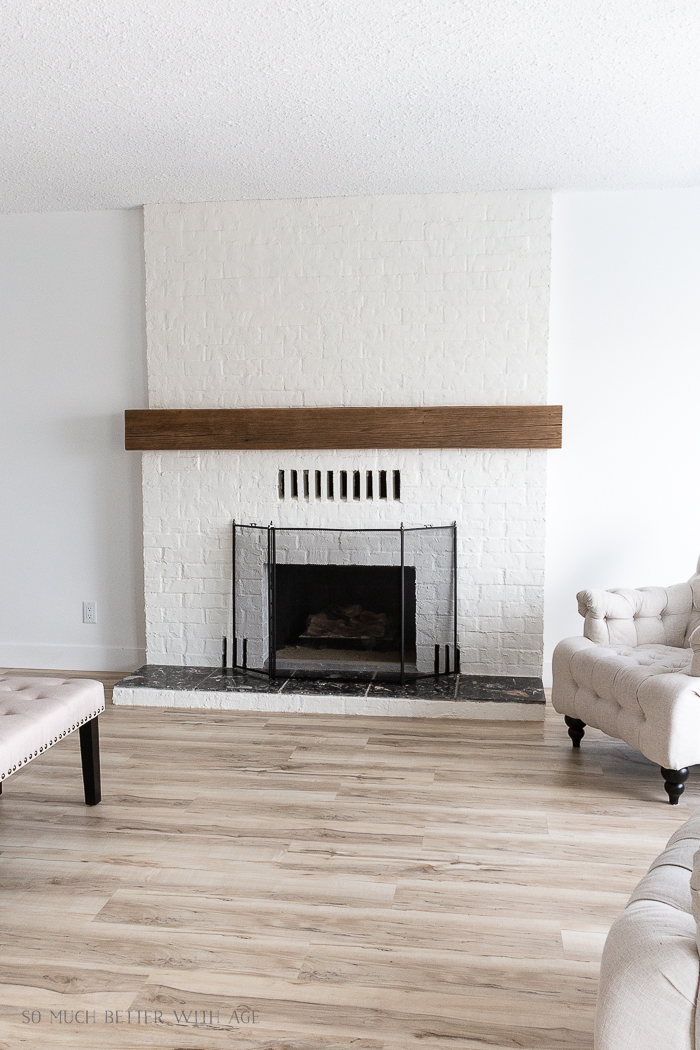 Beautiful plastered brick fireplace in large living room. 