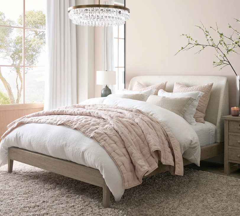 Wood and upholstered bed by Pottery barn called Layton. 