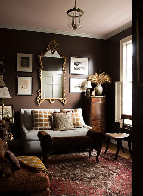 Hearthstone Brown from Benjamin Moore painted in family room with gold vintage artwork. 