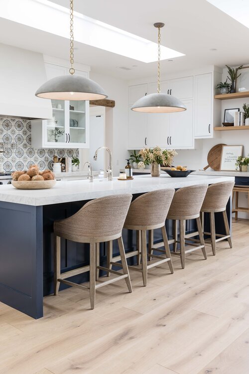 Large grey light fixtures over kitchen island by Pure Salt Interiors. 