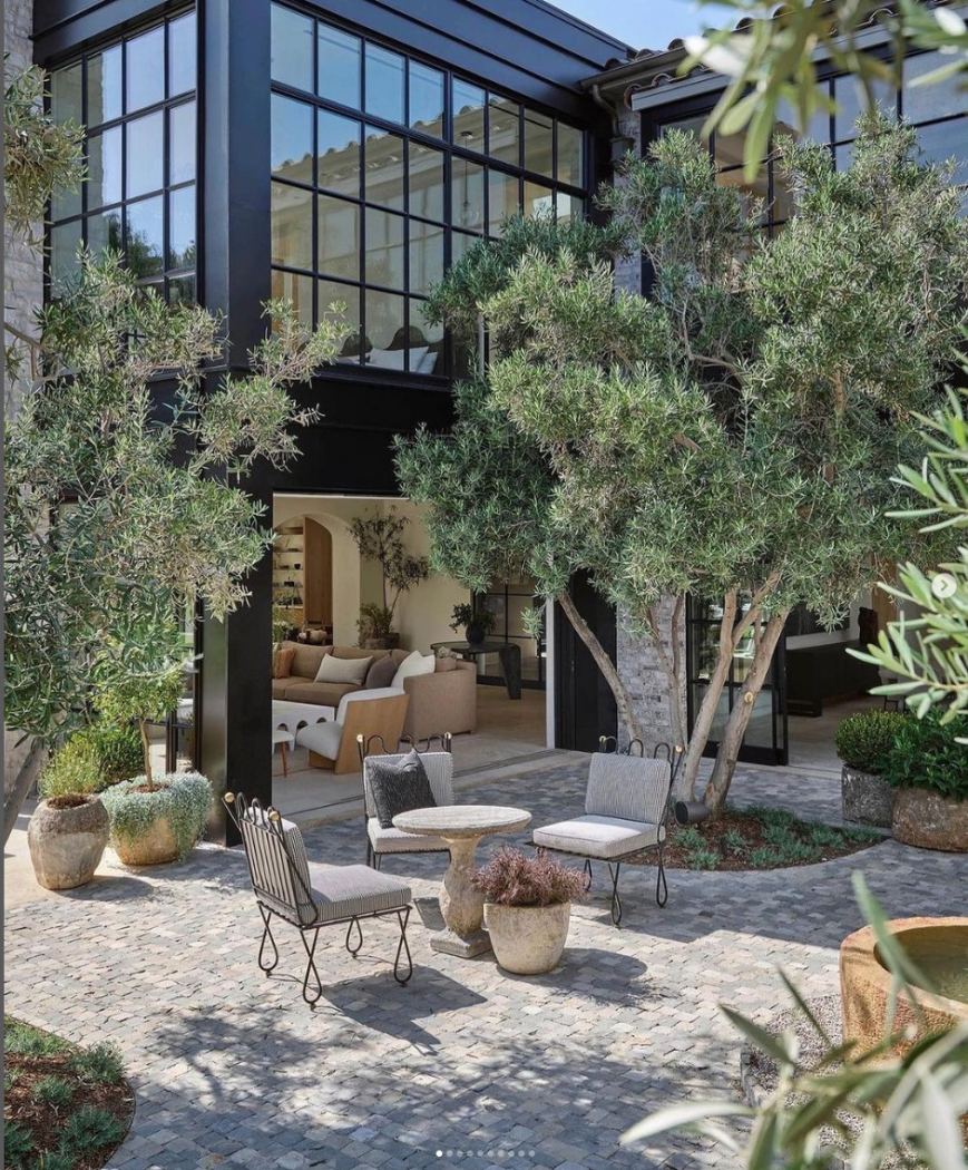Jeremiah Brent design with black modern windows and large outdoor living area. 