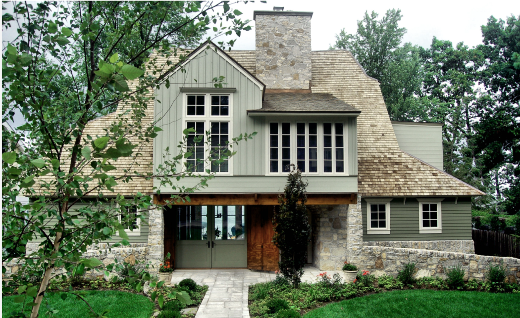 Green colored house with creamy colored trim. 
