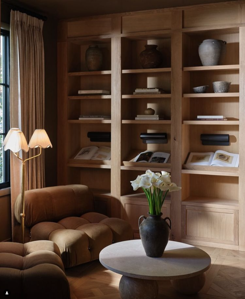 Wooden bookshelf in natural wood color and slanted bookshelves by Light and Dwell.