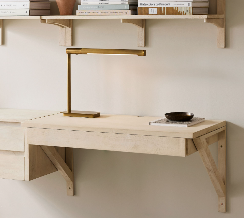 Small wooden desk attached to wall.