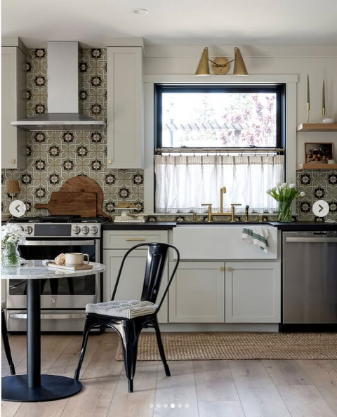 Kitchen design by C. Lehman Home with modern design but green patterned wall tile. 