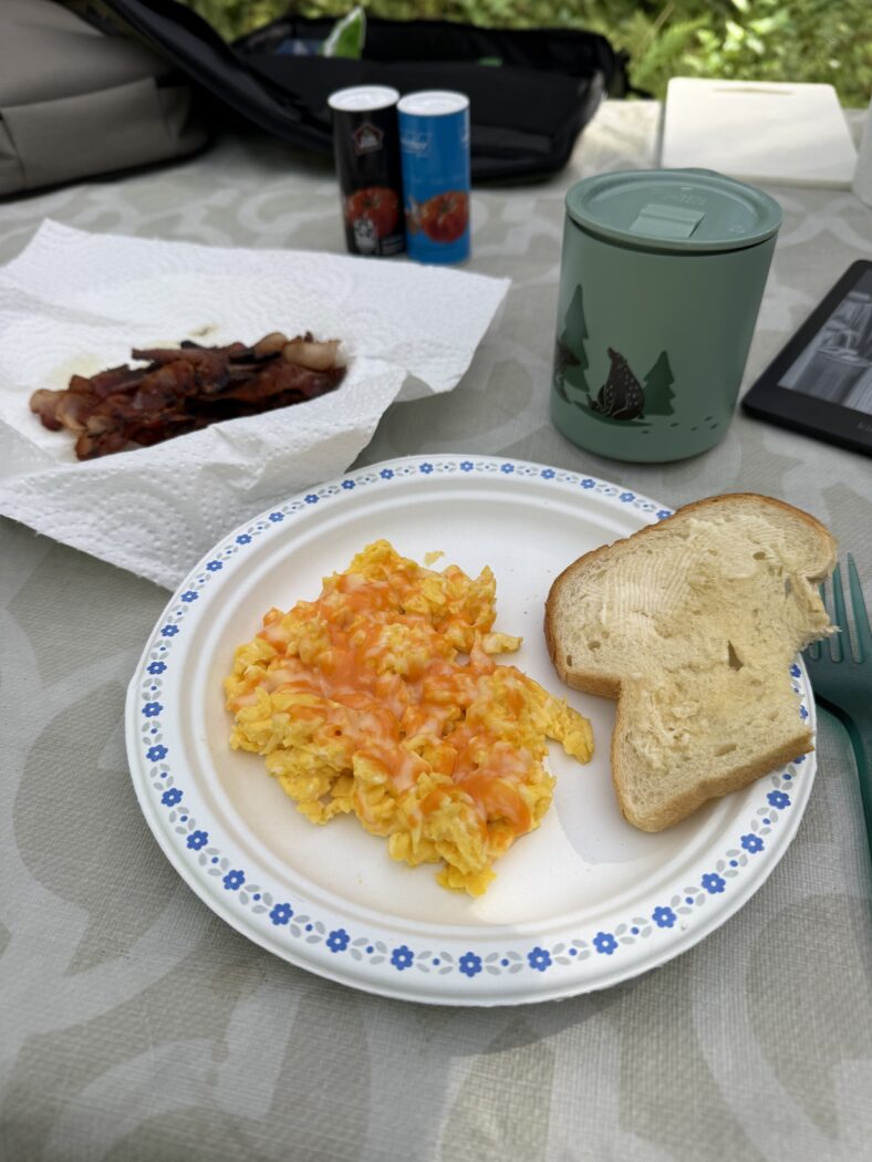 Scrambled eggs, toast, bacon while camping.