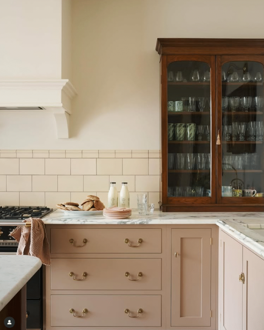 Antique wooden cabinet sitting on marble kitchen countertop. 