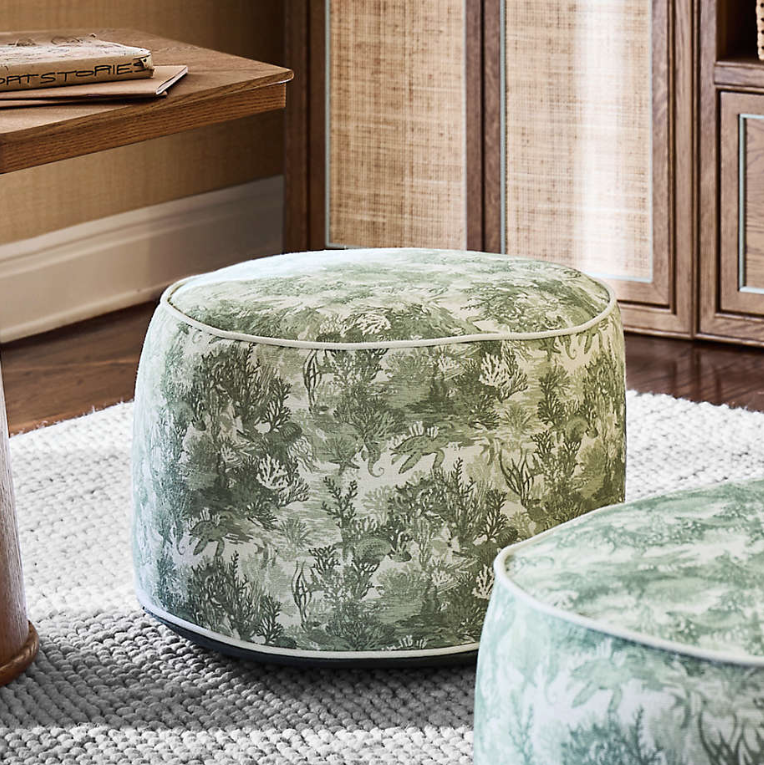 Green tapestry pouf with toile fabric.