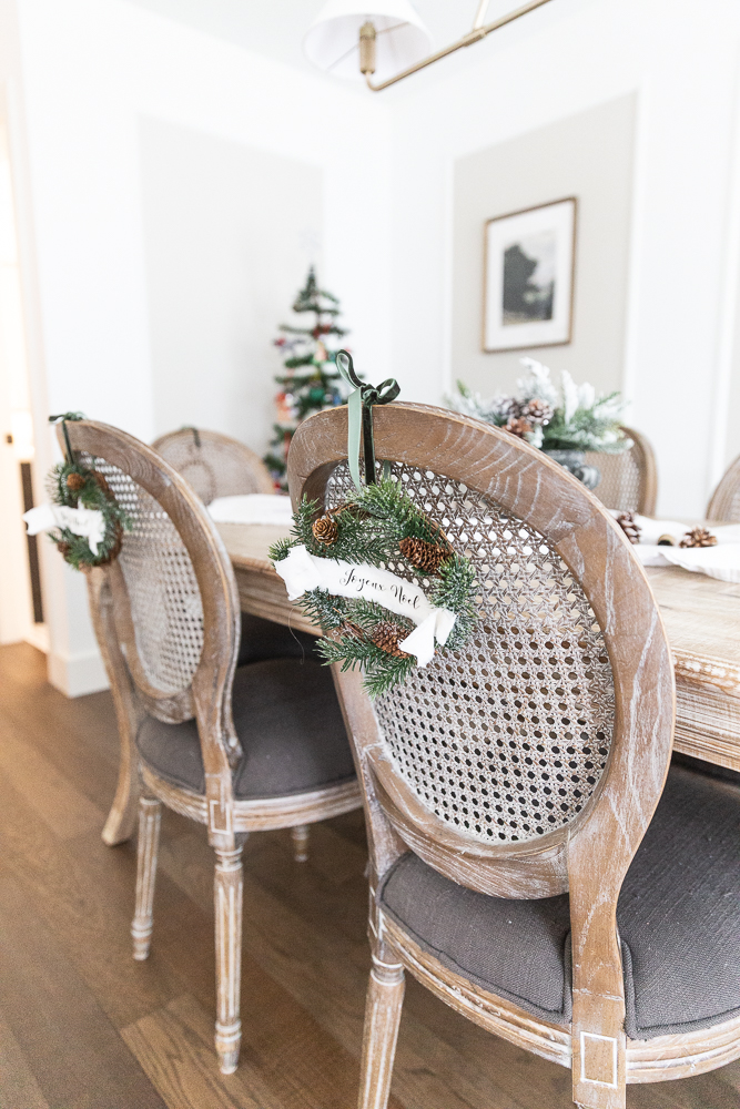 Close up of mini wreaths on back of dining cane back chairs.
